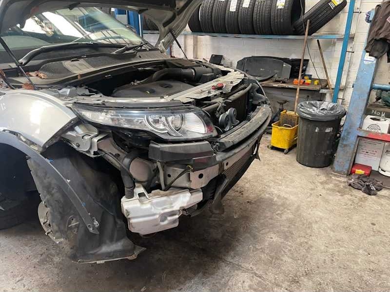 Damaged front end of a car in the workshop