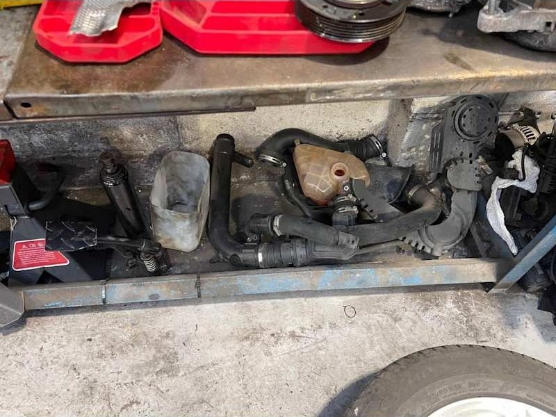 Engine bay plumbing during a repair