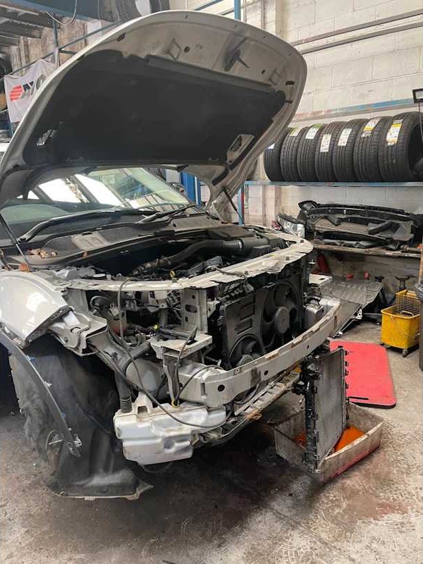 Front of a vehicle stripped in the workshop