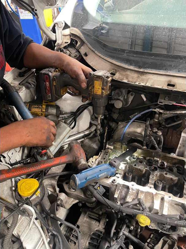 Mechanic using a wrench in the engine bay