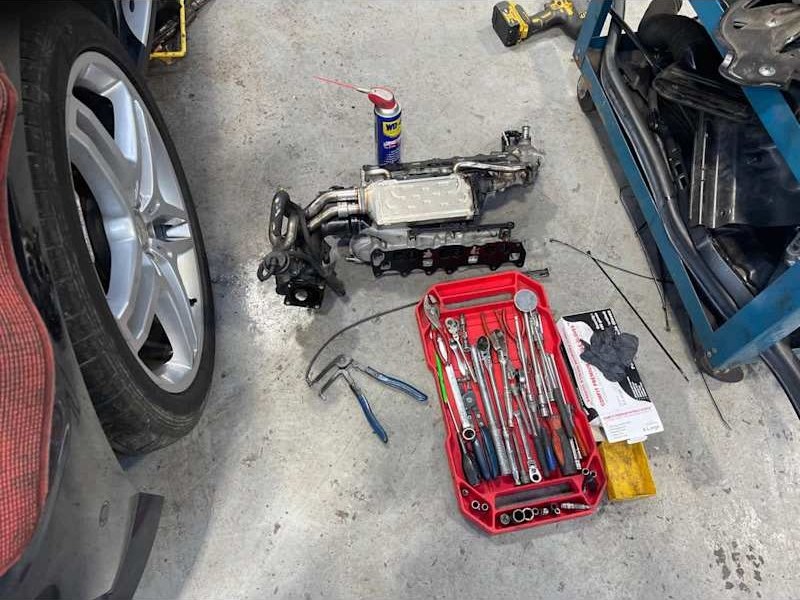Parts and a toolbox beside a wheel
