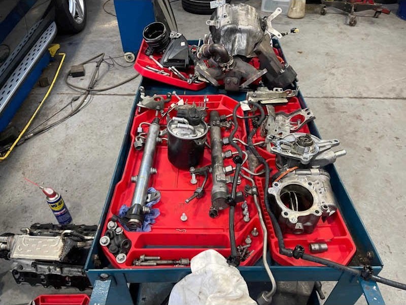 Parts laid out in a tray during a repair