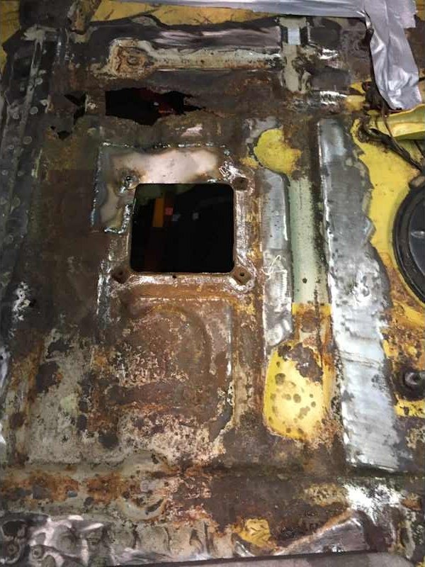 Rusted floor section cut out for repair