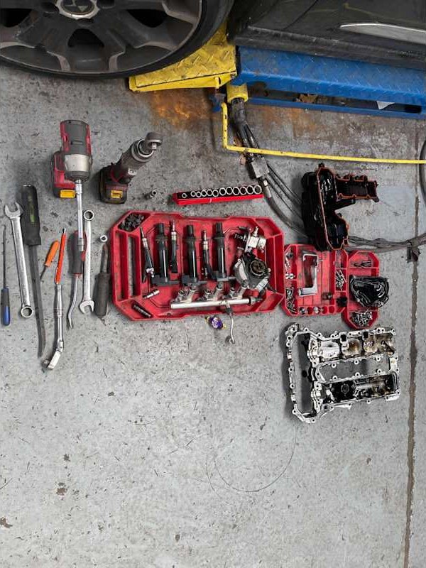Tools and engine parts laid out for a repair