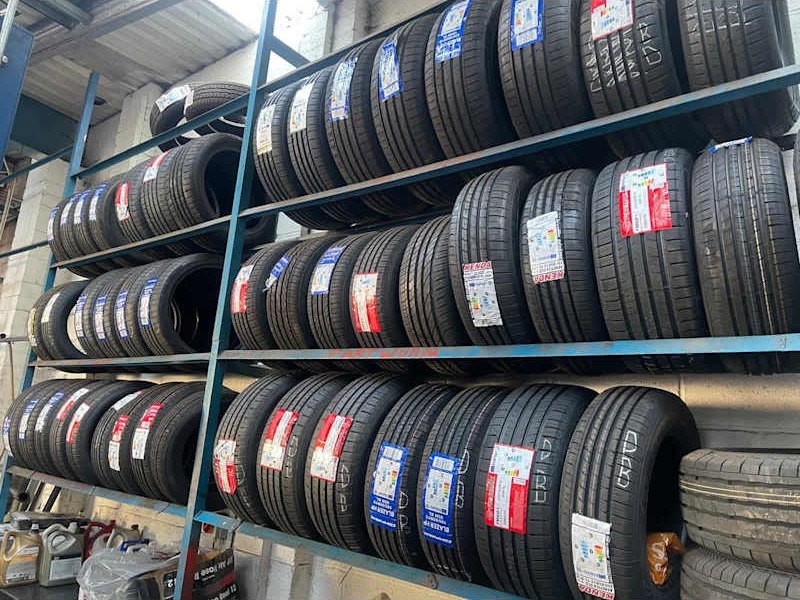 Tyres stacked on racks in the workshop