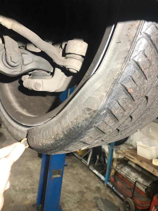 Wheel and tyre raised on the workshop lift